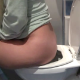 A blonde girl video-records herself having diarrhea while sitting on a toilet while commenting on her bodily functions. No visible poop action. Over 5 minutes.